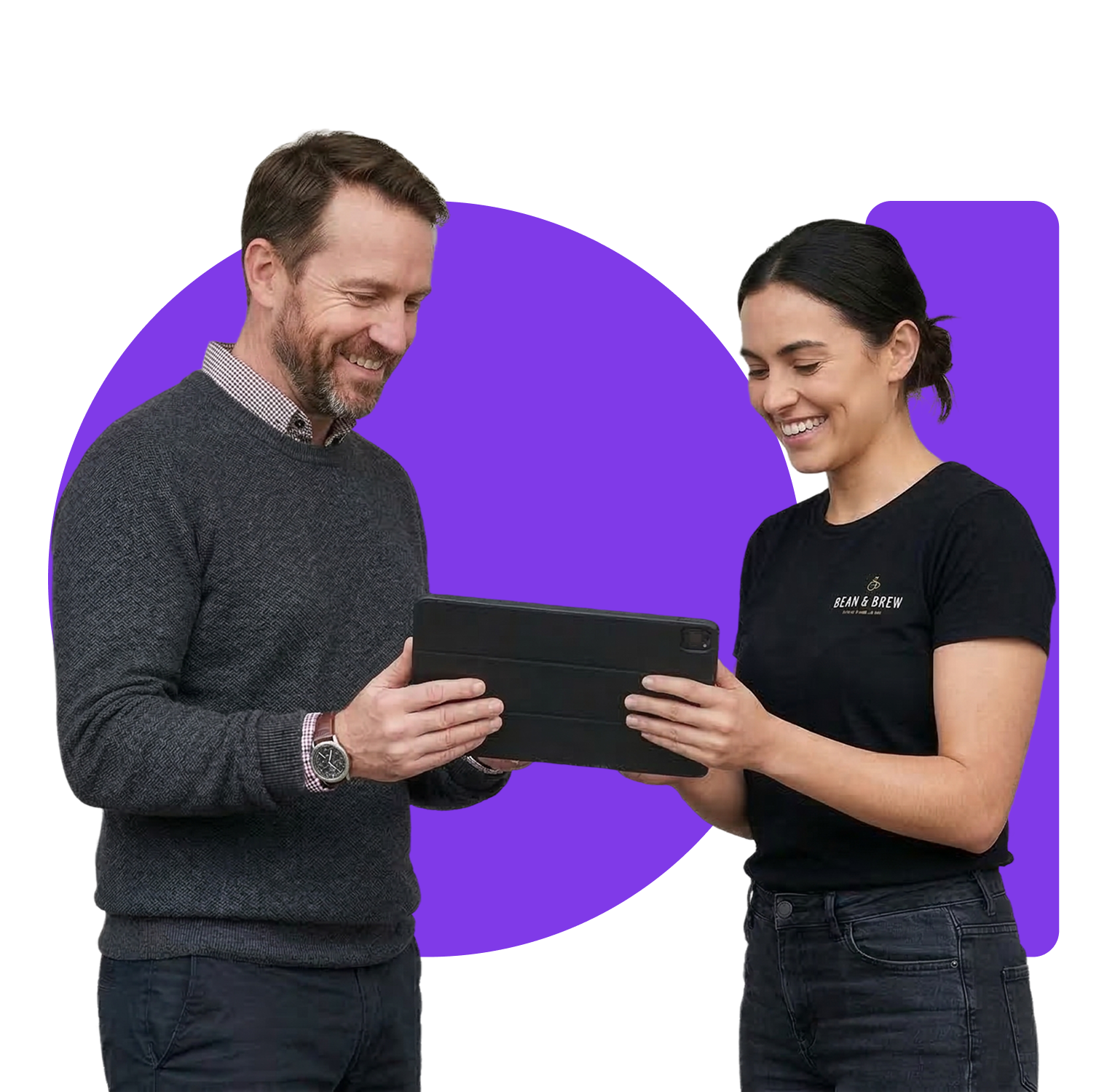 Friendly cafe or restaurant owner reviewing orders on a tablet while talking with a staff member.