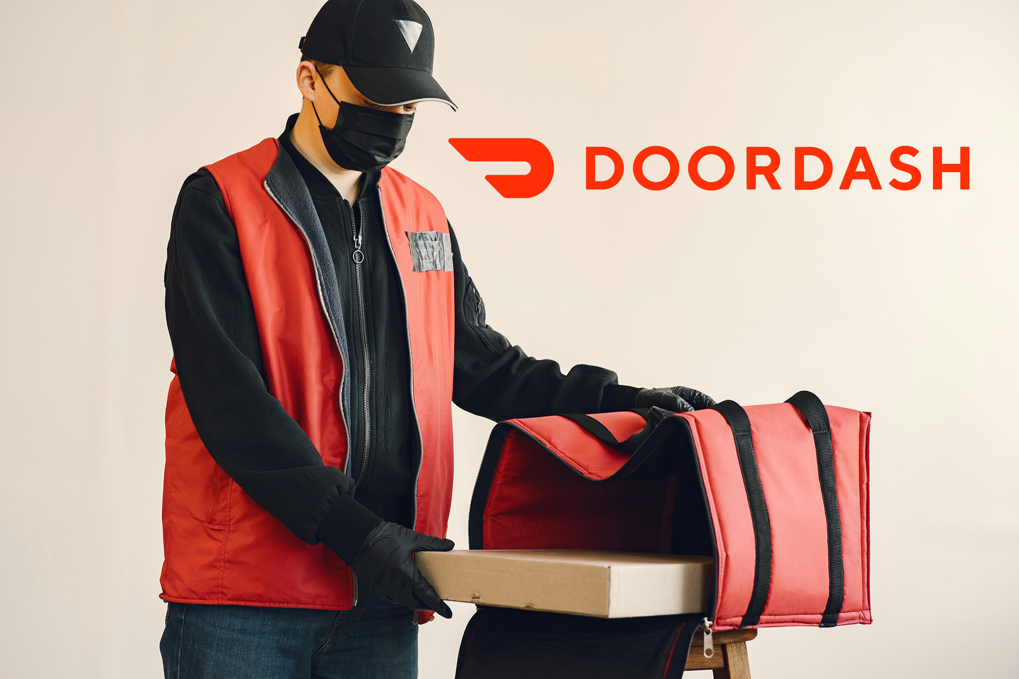 Courier carrying a delivery bag and pizza