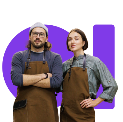 Two cafe owners in leather aprons standing confidently together.