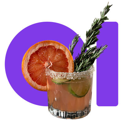 A craft cocktail in a rocks glass garnished with a grapefruit slice, rosemary sprig, and salted rim.