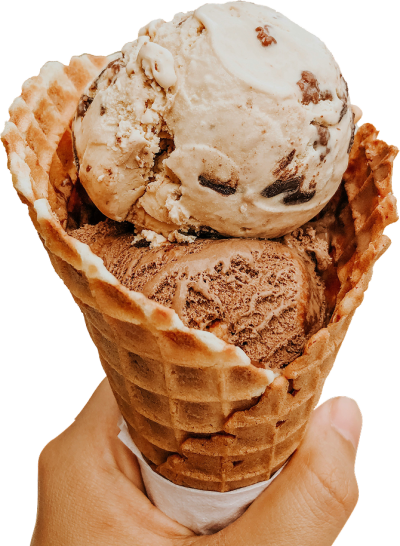 A hand holding a double-scoop ice cream cone in a waffle cone.