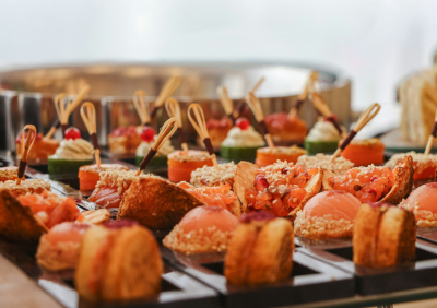 An assortment of canapés and appetisers arranged on a catering serving tray.